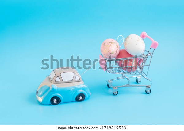 toy car carries a\
cart with Easter eggs