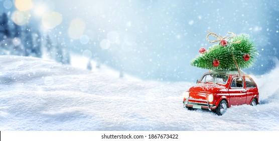 Toy car carrying christmas tree on a roof in snowy winter forest. Christmas background. Holidays card. - Powered by Shutterstock