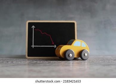Toy Car And Chalkboard With Downward Arrow Graph. Car Rental Dealer Decrease Lost Sales Concept.