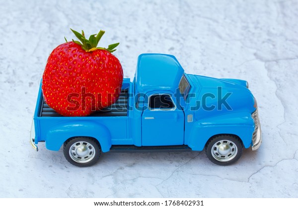 toy car \
delivering fresh large ripe\
strawberry