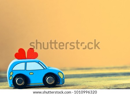 toy car delivering heart for Valentine's day on  background