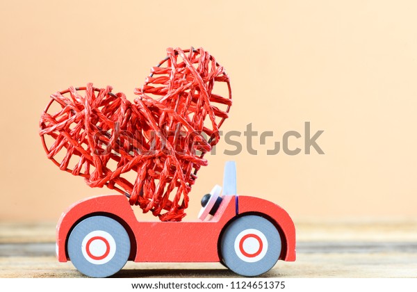 toy car delivering heart for Valentine\'s day\
on background