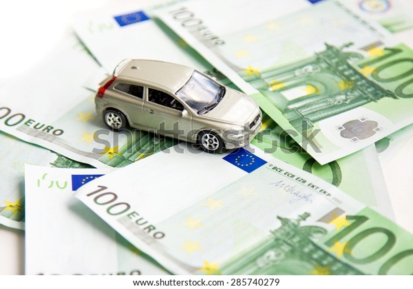 Toy car and euro on\
white
