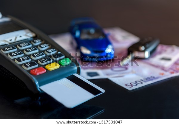 Toy car with\
euro and terminal with credit\
card