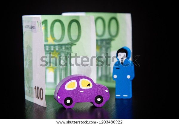 Toy car,\
euros and businessmen on black\
background