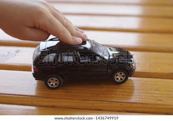 toy car in the hand of a\
small boy