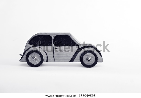 Toy car isolated on white background with copy\
space.Concept photo of car business, car Insurance, auto\
dealership,car rental ,safe driving ,buying, renting, fuel, service\
and repair costs (BW)
