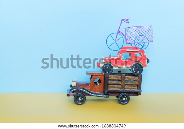 Toy car,\
lorry and bike on the blue\
background.