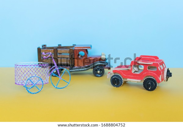 Toy car,\
lorry and bike on the blue\
background.