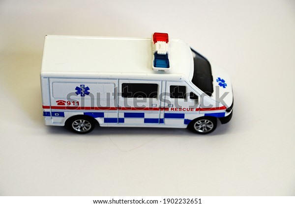 toy car medical rescue service close up on white\
background, copy space.