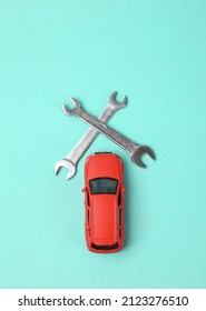 Toy Car Model With Wrench On Blue Background. Auto Service, Repair Concept. Top View