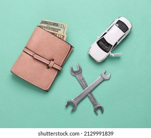 Toy Car Model With Wrench And Purse On Blue Background. Auto Service, Repair Concept. Top View