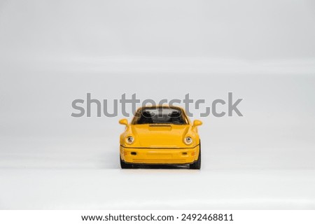 Toy car models in scale on a white background