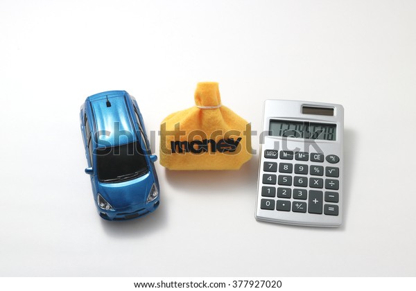 Toy car, money and calculator\
isolated on white background. Rent, buy or insurance car concept.\

