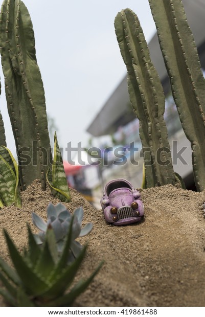 Toy car on the artificial\
desert.