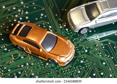 Toy Car On Electronic Board And Microchip. Conceptual Image For Semiconductor Shortage Disrupting Production Of The Automotive Industry.