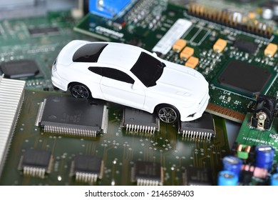 Toy Car On Electronic Board And Microchip. Conceptual Image For Semiconductor Shortage Disrupting Production Of The Automotive Industry.