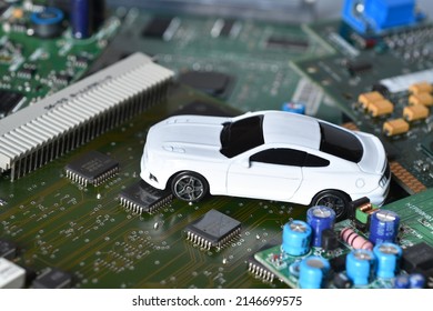 Toy Car On Electronic Board And Microchip. Conceptual Image For Semiconductor Shortage Disrupting Production Of The Automotive Industry.