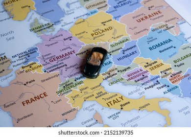 Toy Car On Europe Map, Side View, World Trip Concept, Miniature Green Sport Car Going To Italy, Country And Europe Tour