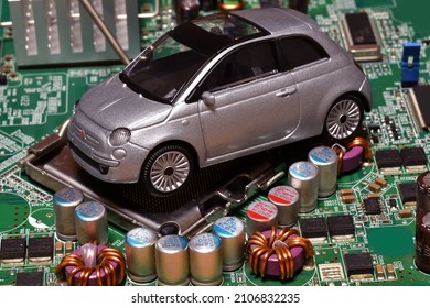 Toy car on motherboard cpu socket. The shortage of semiconductors creates a shortage of new cars. Conceptual image for semiconductor shortage disrupting production of the automotive industry.