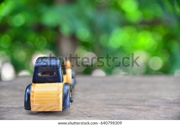 Toy car on wood\
texture.