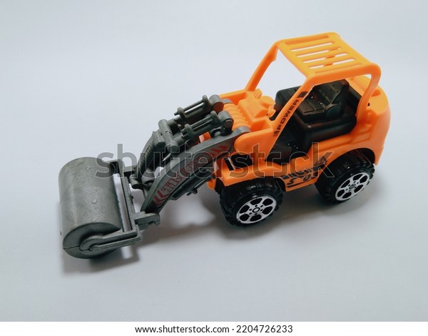 toy car,\
orange color vehicle on white\
background.