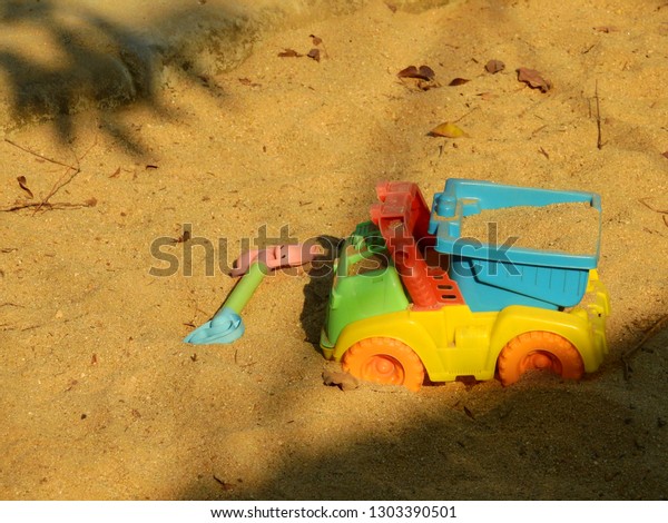 \
Toy car in the sand\
box