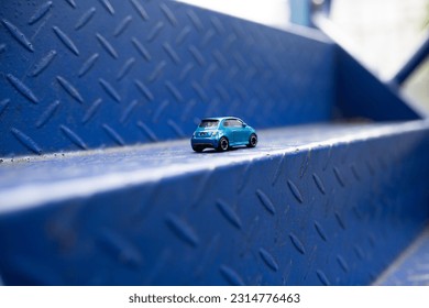 Toy car at the slide step at playground