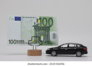 A Toy Car Stands Next To A Banknote On A Stand. Accurate Financial Calculation When Buying A Car