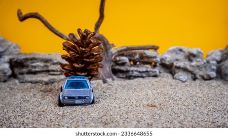 toy car transporting pinecones on an orange background - Powered by Shutterstock