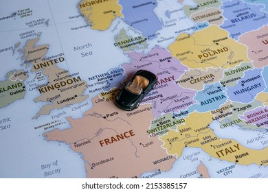 Toy car travels on Europe map, Europe map idea, holiday in France, sitting view, vacation and destination concept, miniature green sport car going to France from Germany, worldwide tour - Powered by Shutterstock