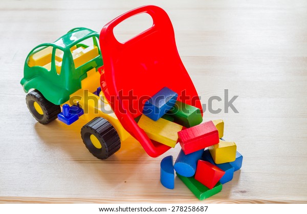 Toy car truck dumping\
bricks