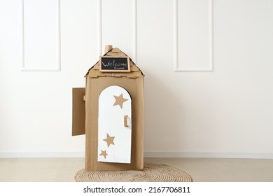 Toy Cardboard House With Chalkboard Near Light Wall