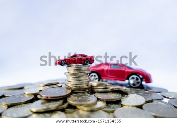 Toy cars with gold coins show To growth, saving
money for car loans.