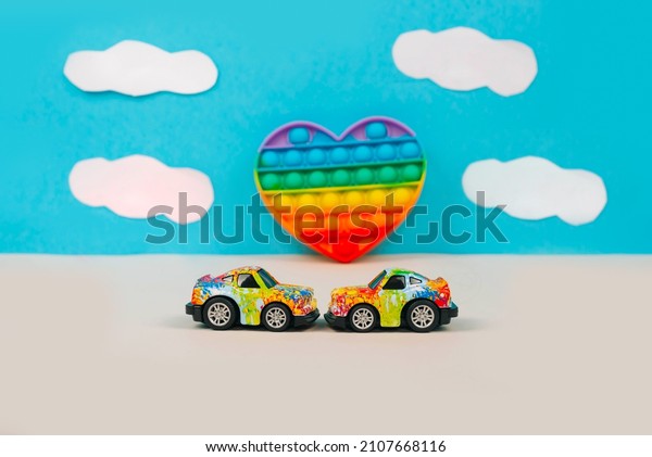 Toy cars with graffiti in the\
style of LGBTQ on the background of a heart pop it. Concept of\
transgender people in communities - Russia, Moscow,\
27.08.2021
