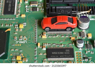 Toy Cars On Electronic Board And Microchip. Conceptual Image For Semiconductor Shortage Disrupting Production Of The Automotive Industry.