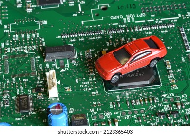 Toy Cars On Electronic Board And Microchip. Conceptual Image For Semiconductor Shortage Disrupting Production Of The Automotive Industry.