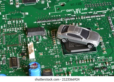 Toy Cars On Electronic Board And Microchip. Conceptual Image For Semiconductor Shortage Disrupting Production Of The Automotive Industry.