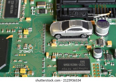 Toy Cars On Electronic Board And Microchip. Conceptual Image For Semiconductor Shortage Disrupting Production Of The Automotive Industry.