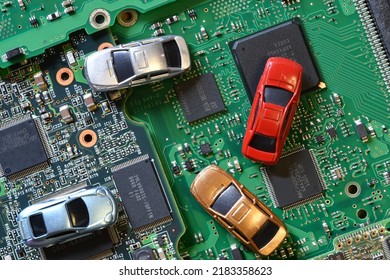 Toy Cars On Electronic Board And Microchip. Conceptual Image For Semiconductor Shortage Disrupting Production Of The Automotive Industry.
