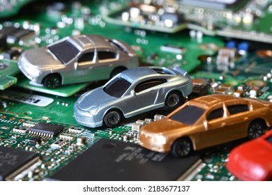 Toy Cars On Electronic Board And Microchip. Conceptual Image For Semiconductor Shortage Disrupting Production Of The Automotive Industry.
