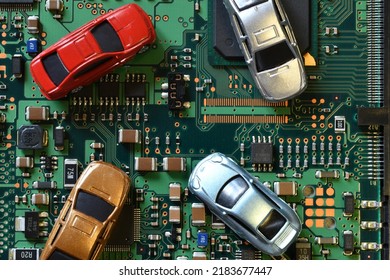 Toy Cars On Electronic Board And Microchip. Conceptual Image For Semiconductor Shortage Disrupting Production Of The Automotive Industry.
