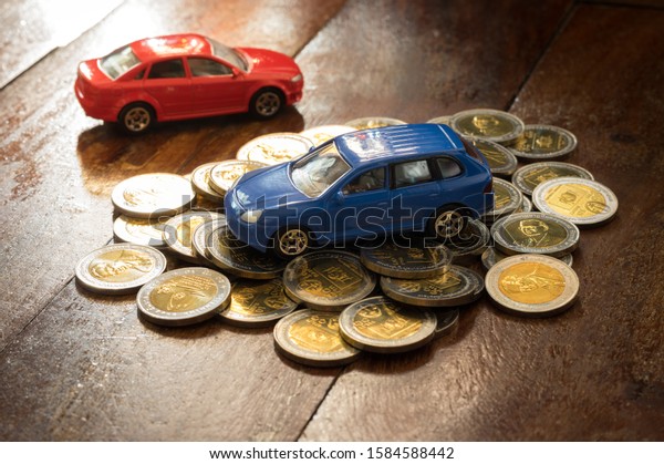 Toy cars on gold money coins.No trade mark or\
invalid sign on coins.