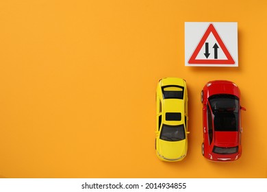 Toy Cars And Road Sign Two Way Direction On Yellow Background, Flat Lay. Space For Text