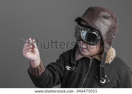 toy, child playing the aircraft pilot with hat and retro bomber jacket