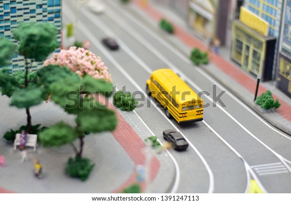 Toy city with small car model running on the road,\
Selective focus 