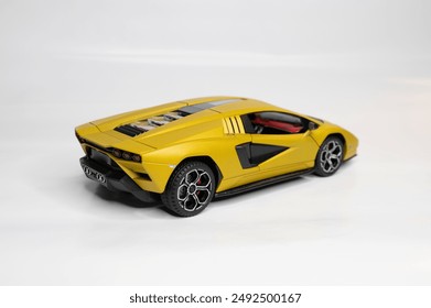Toy colored car models in scale on a white background