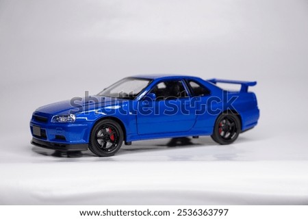 Toy colored car models in scale on a white background