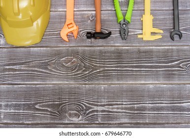 Toy Construction Tool, Helmet On The Background Of Wood. Building Sector.