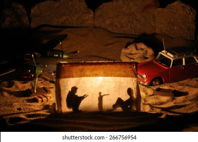 Toy desert story, pilot Antoine de Saint Exupery meets rally driver at the campfire and little prince join them on Planet of People